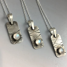 close-up of three small pendants in a row