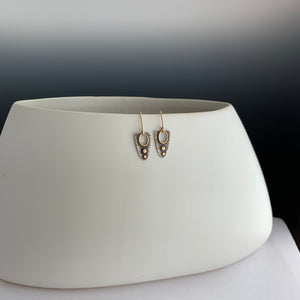 modern sterling and gold earrings with see-through opening framed in 14k gold