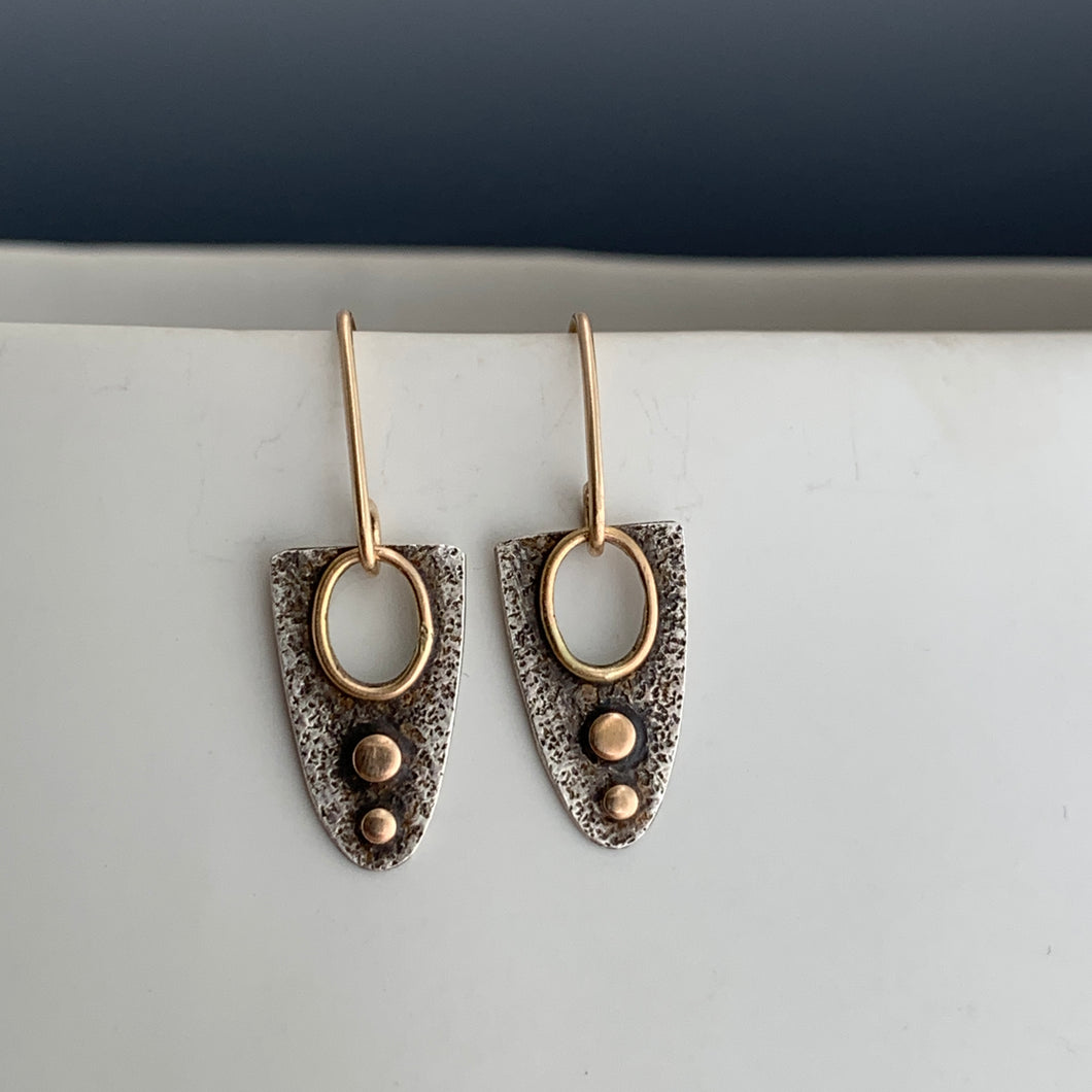 textured sterling silver dangle earrings with 14k gold accents and gold-framed cut-out with gold ear wires