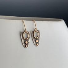 half eclipse shaped earrings in sterling silver with gold dots and accents and gold ear wires