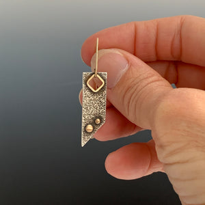 single modern love earring held in hand to show size modern dangle earring