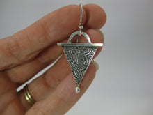 sterling silver long earrings with pattern modeled in hand for size comparison